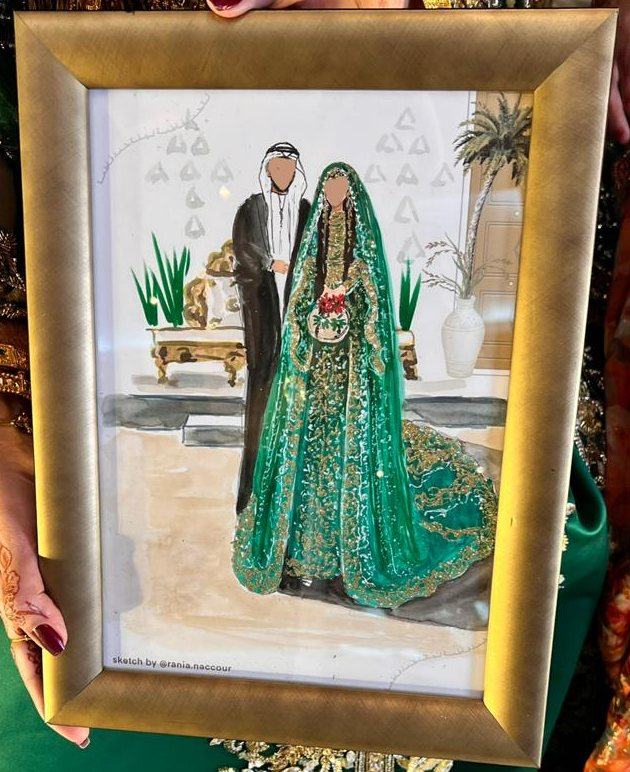 Bride in a green and gold henna dress with the groom