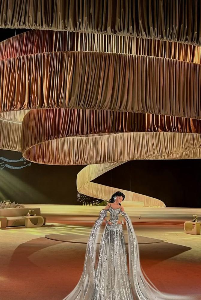 Silver gown illustration in a draped hall